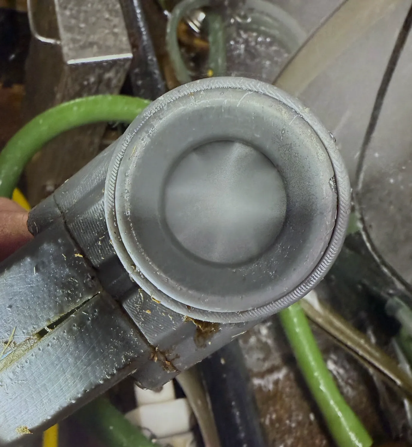 SaniTeat device front view showing the teat cup and spray nozzle